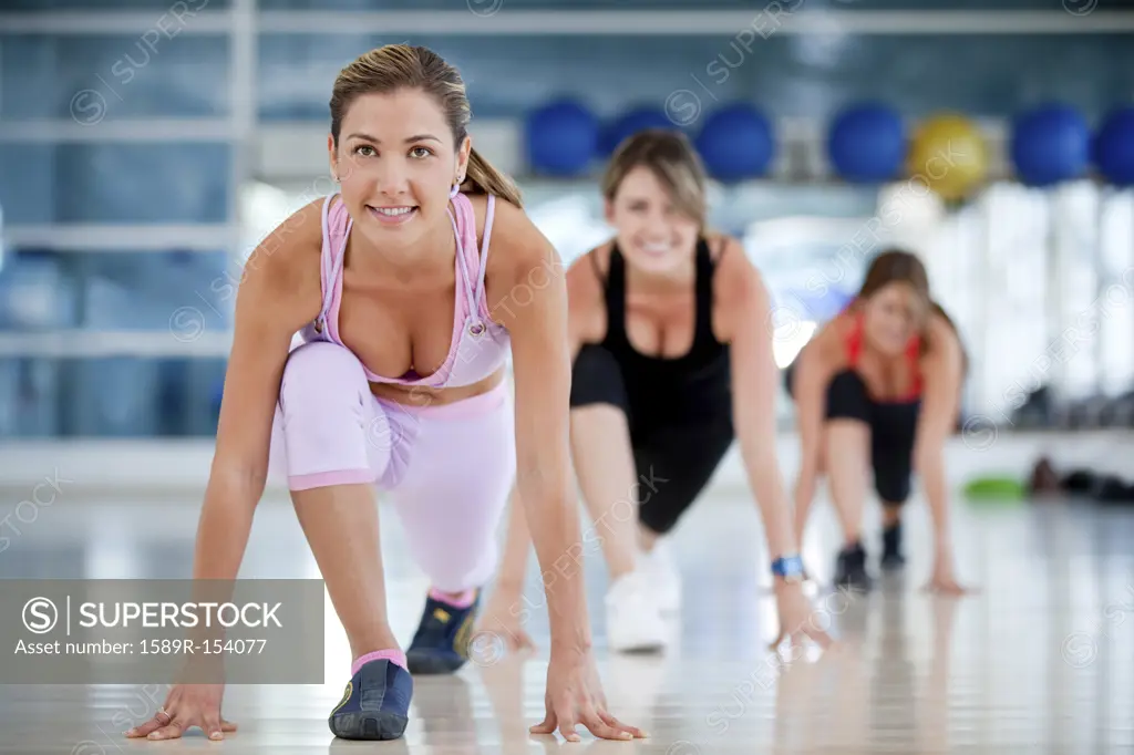 Hispanic women exercising in health club