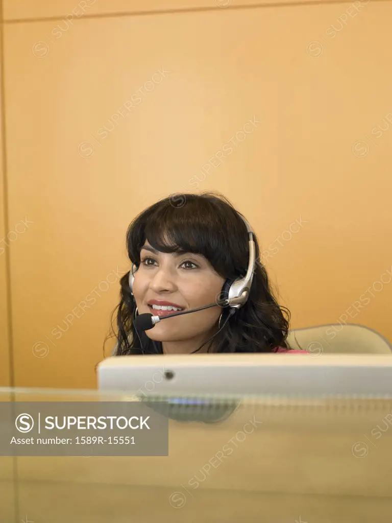 Businesswoman using a headset at her desk