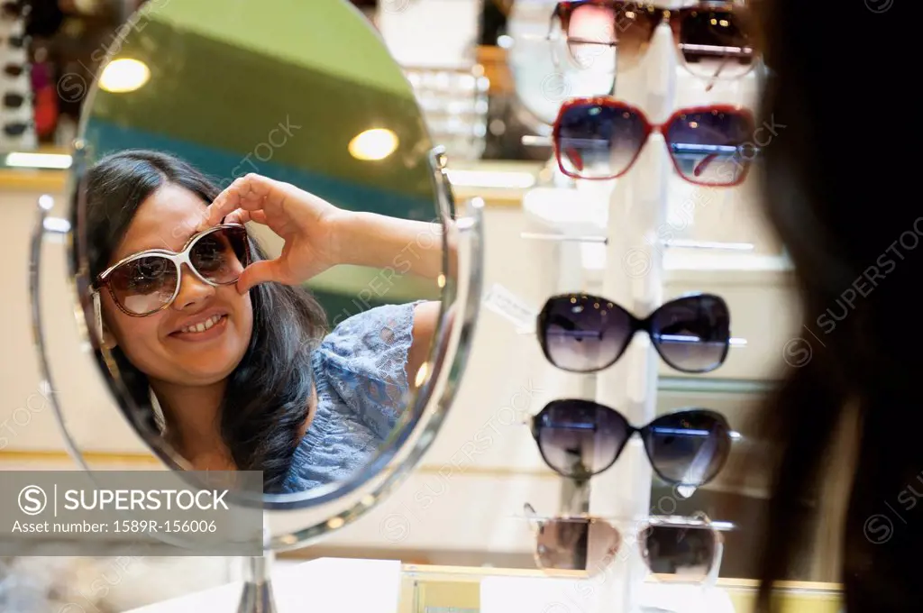 Mixed race woman shopping for sunglasses