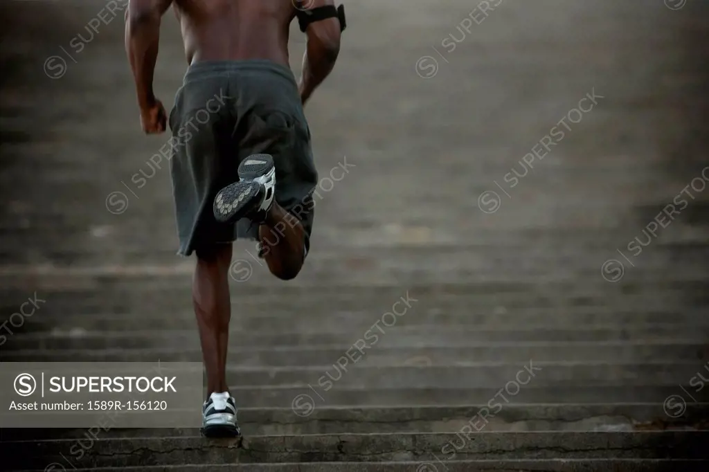 Black man running up stairs