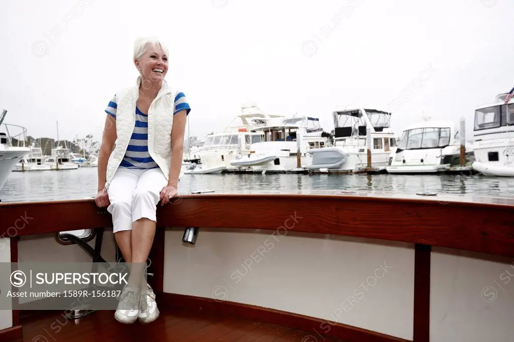 Smiling woman sitting on boat