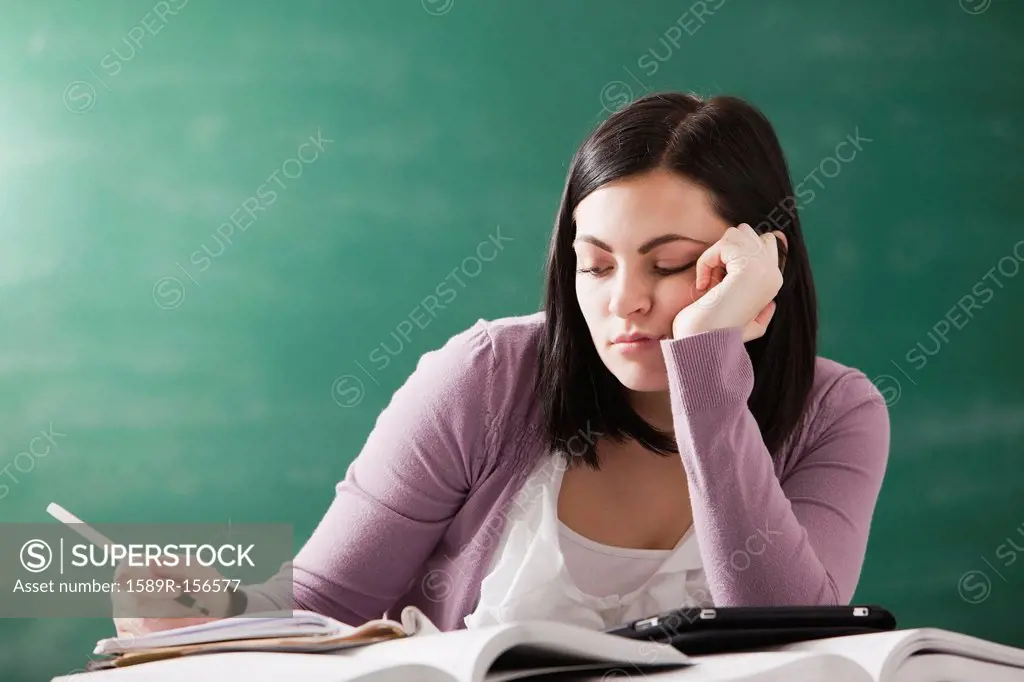 Bored Caucasian student doing homework