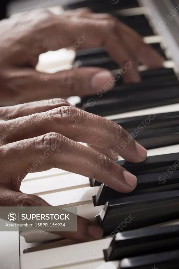 Mixed race man playing the piano