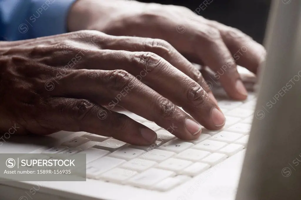 Mixed race man typing on laptop