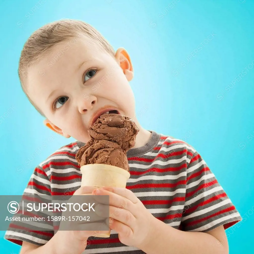 Caucasian boy eating ice cream cone
