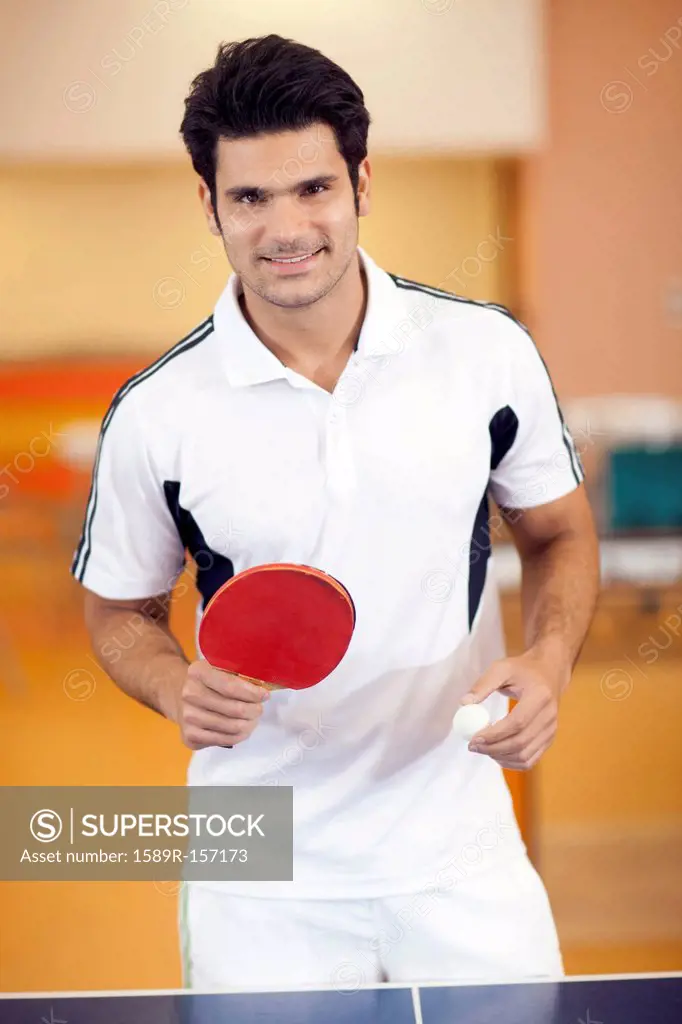 Hispanic man playing ping pong