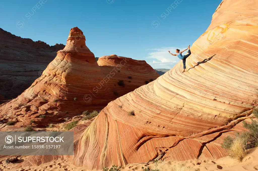 Caucasian woman practicing yoga outdoors