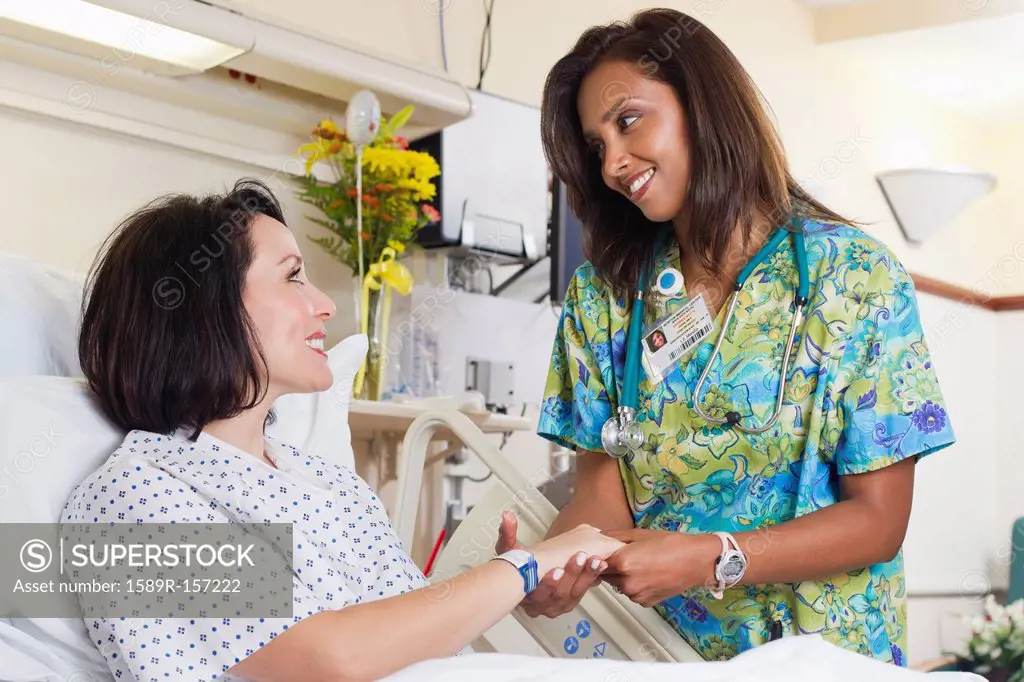 Nurse comforting patient in hospital
