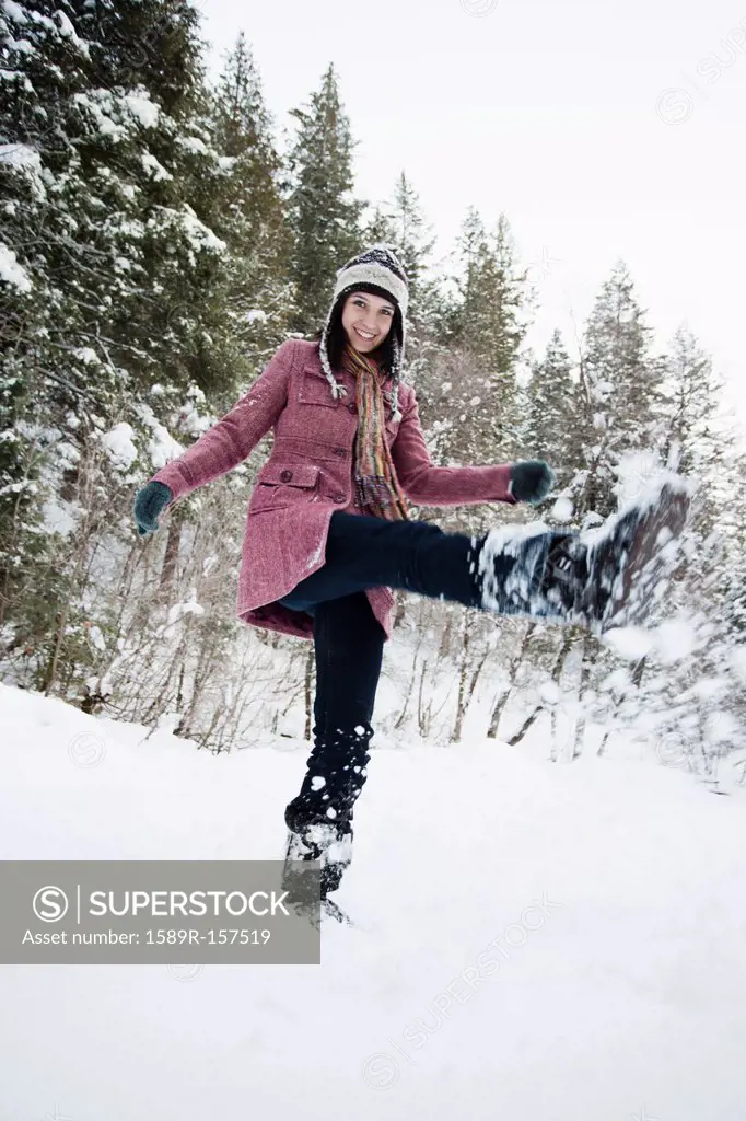 Caucasian woman playing in the snow
