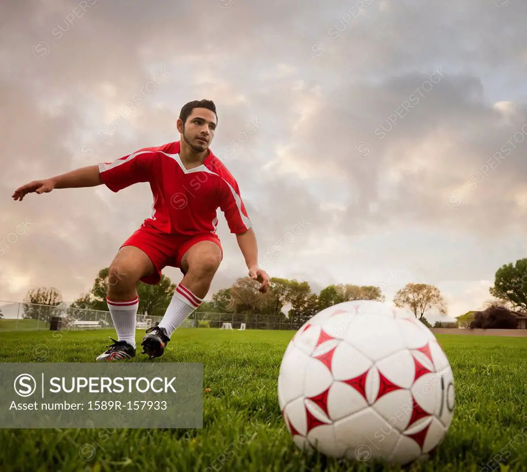 Hispanic soccer player about to kick the ball