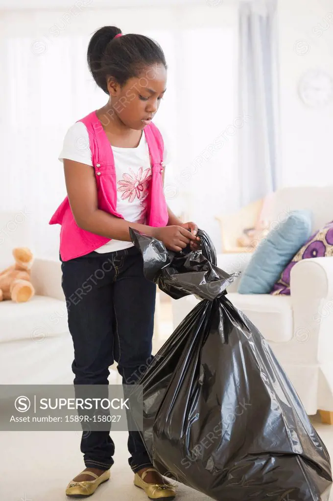 Black girl taking out the garbage