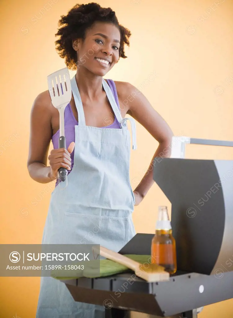 Black woman grilling on barbecue