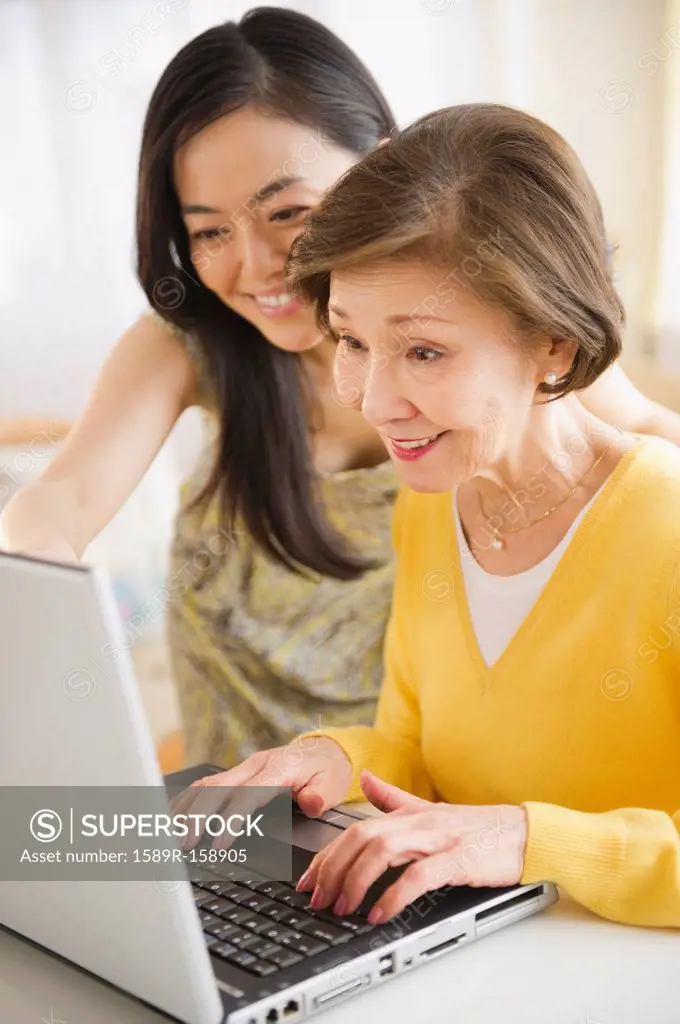 Japanese mother and daughter using laptop together