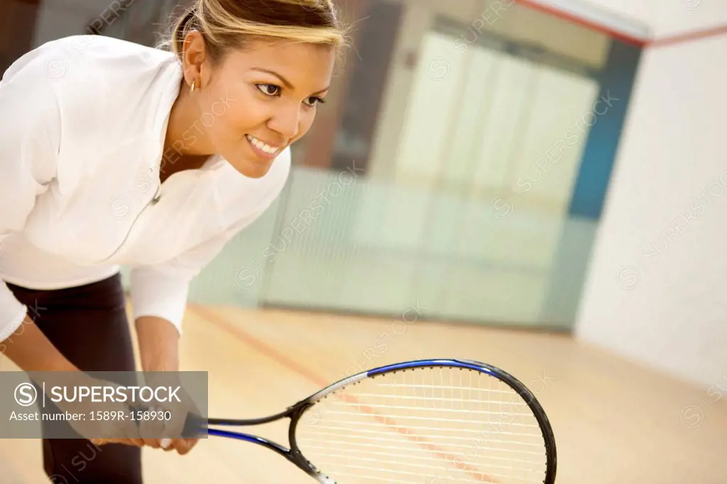 Hispanic woman playing squash