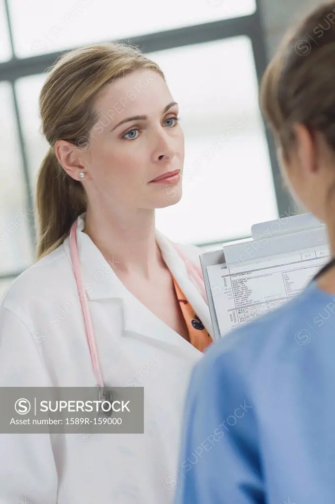 Doctors talking together in hospital