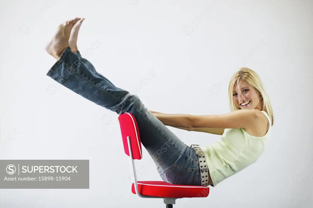Young woman playing in a chair
