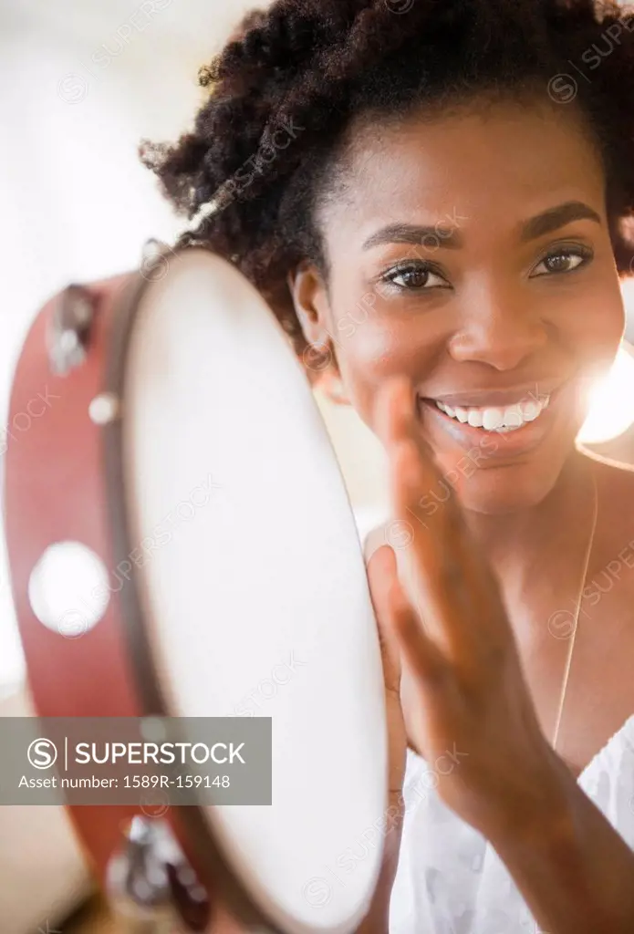 Black woman holding tambourine