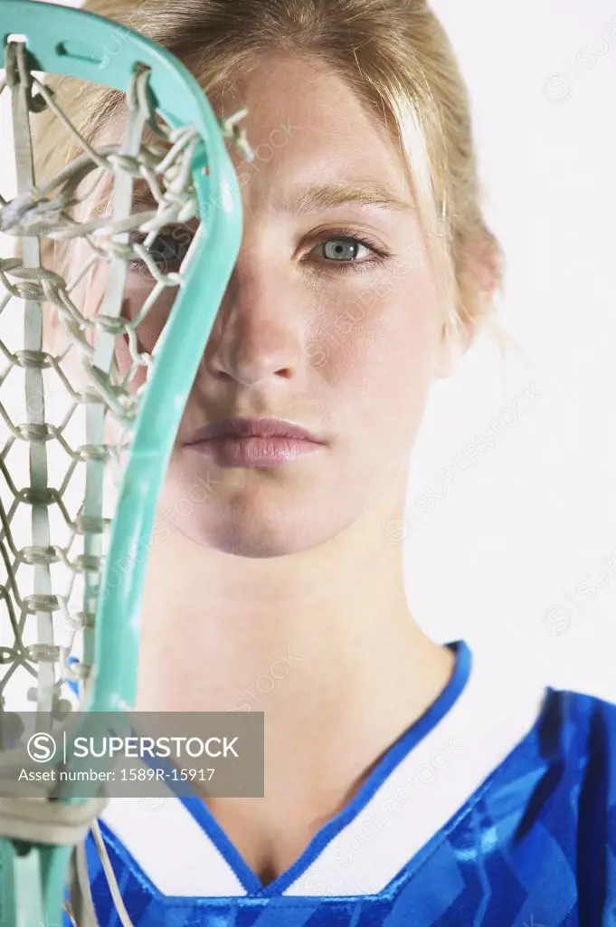 Female lacrosse player holding lacrosse stick