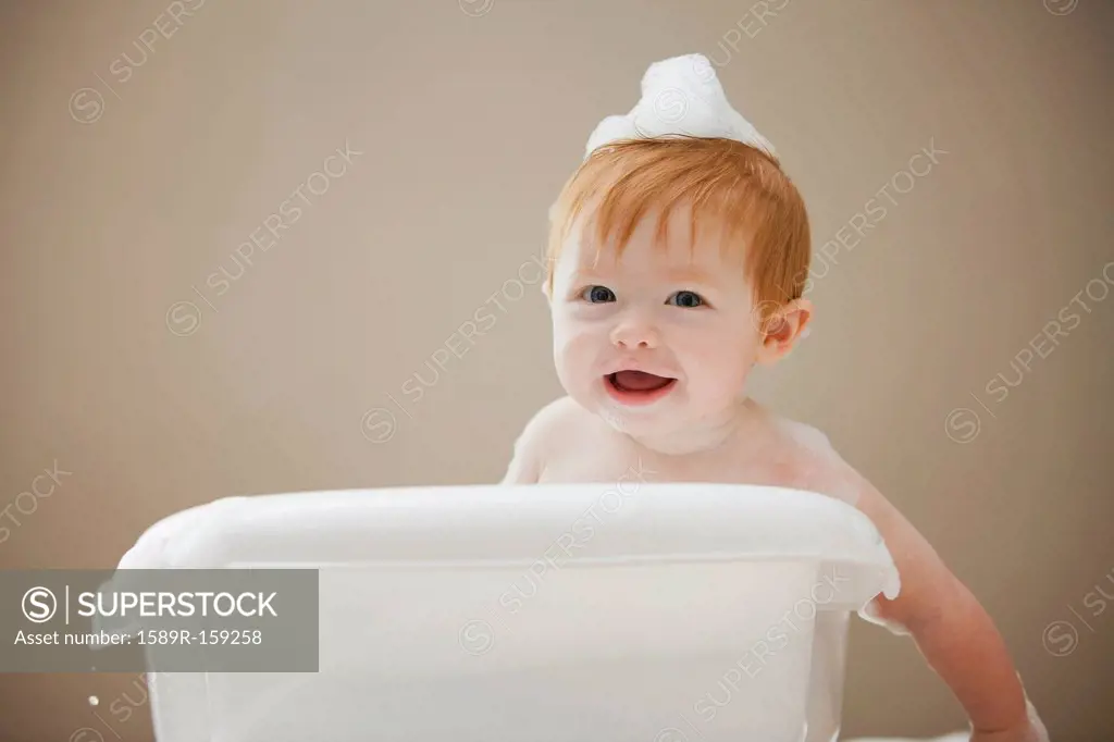 Caucasian baby girl having a bath