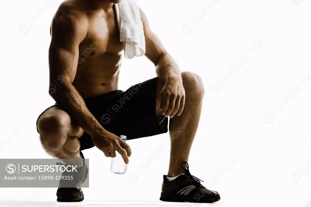 Caucasian man drinking water after exercise