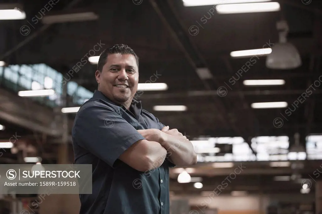 Hispanic worker standing in warehouse