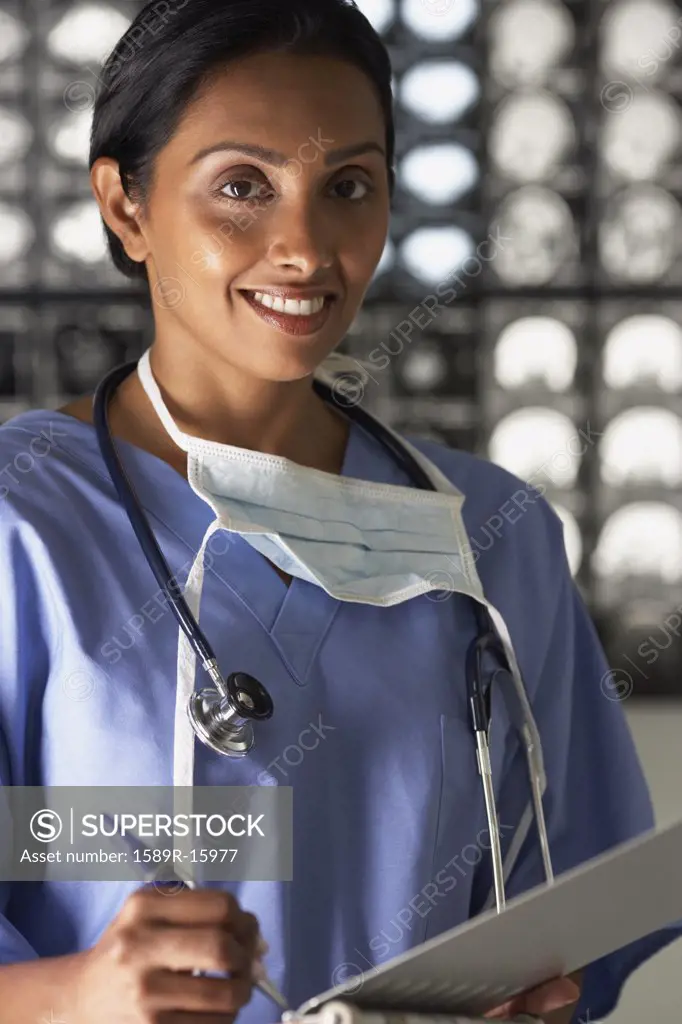 Portrait of female doctor writing notes