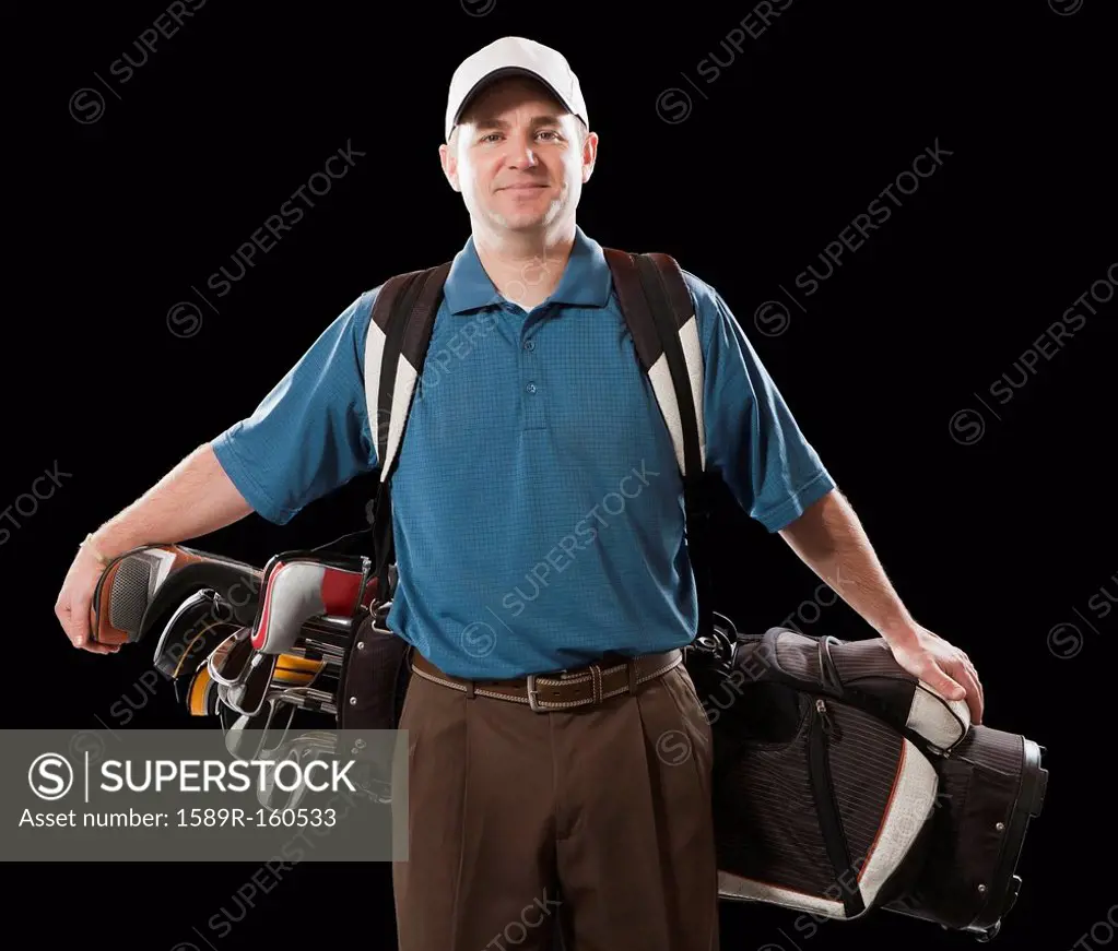 Caucasian golfer carrying golf bag