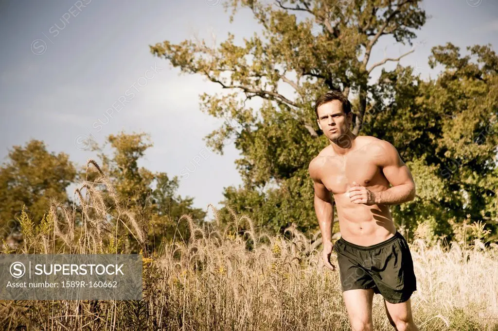 Caucasian man running outdoors