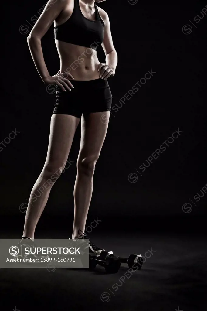 Caucasian woman standing with hand weights