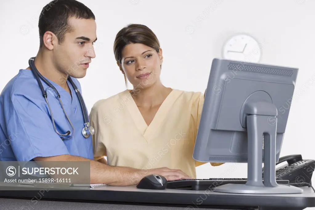 Nurses looking at computer monitor