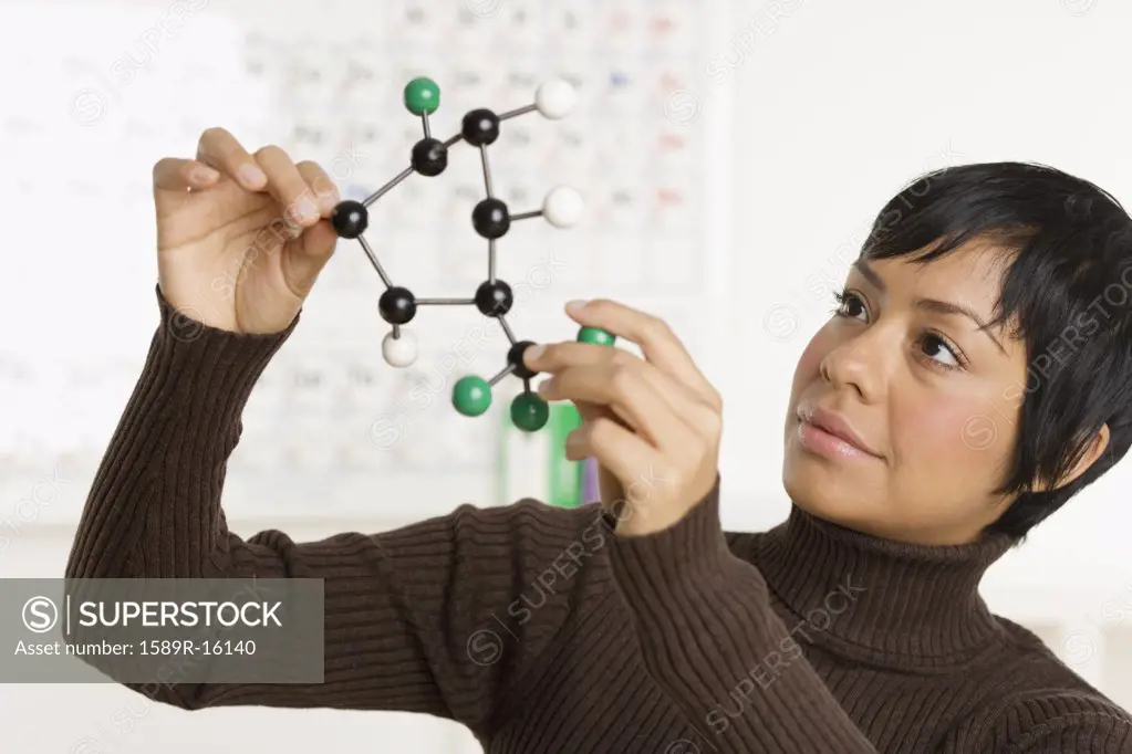 Portrait of woman holding science model
