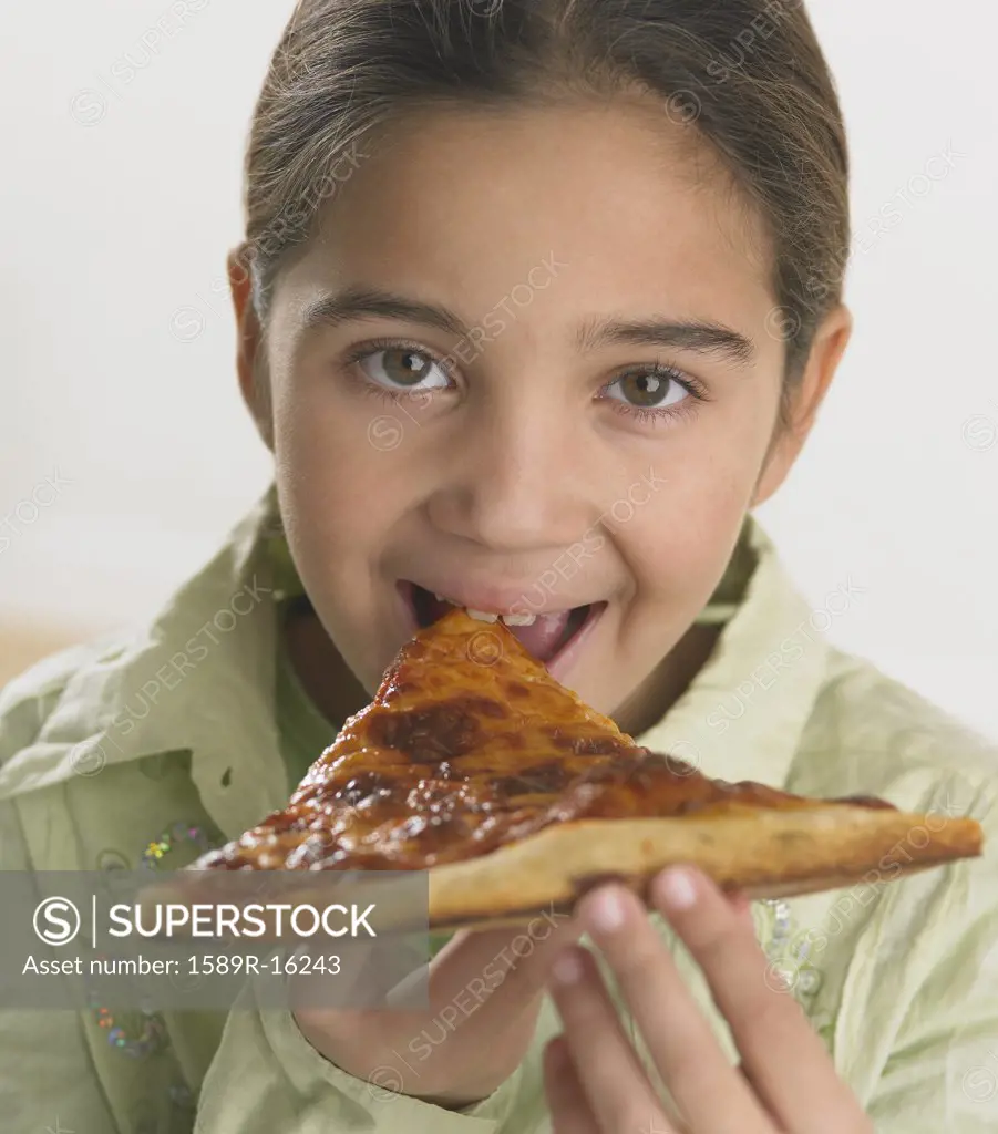 Young girl eating pizza