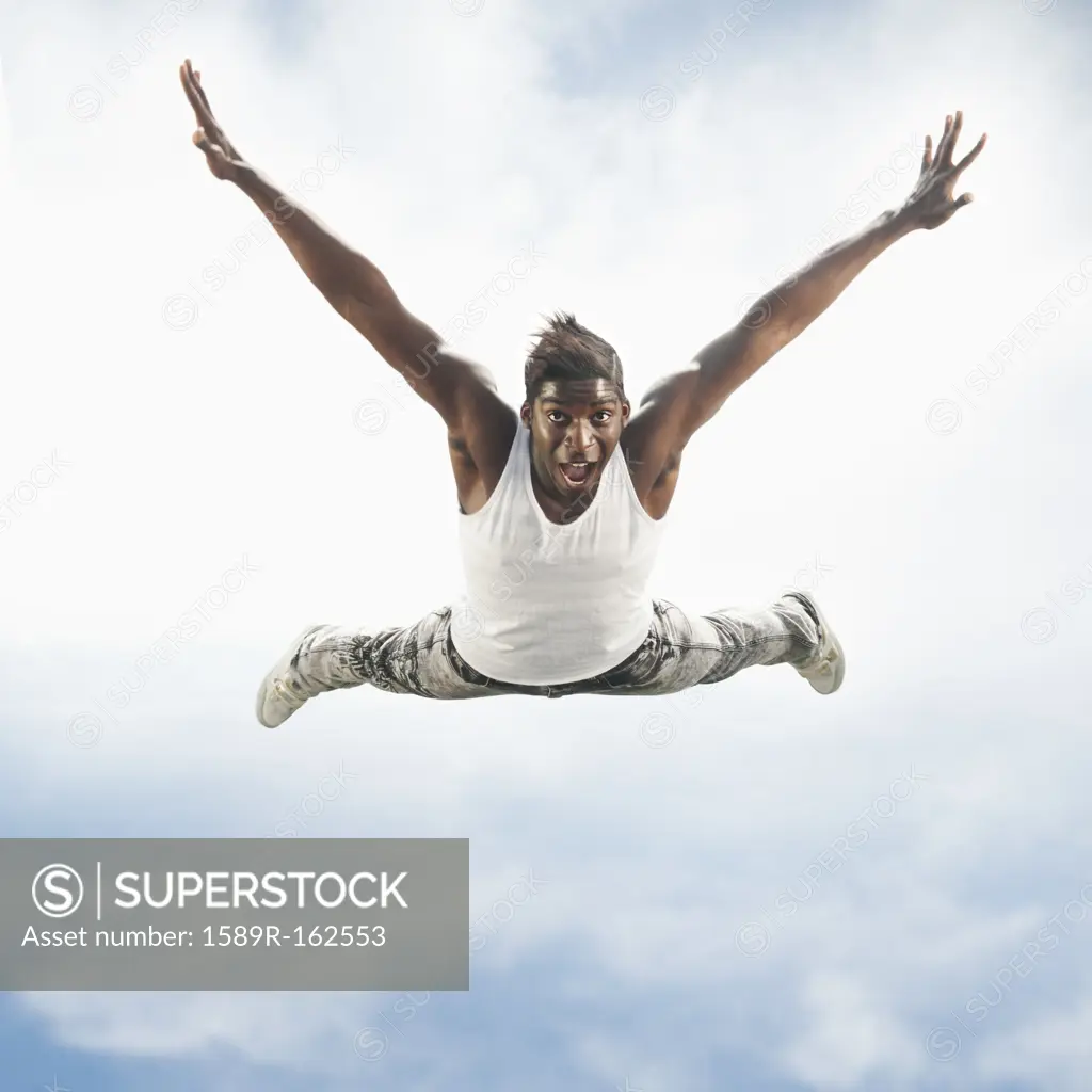 African American man jumping in mid_air