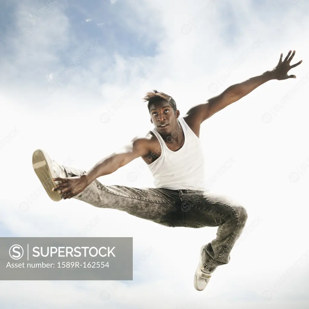 African American man jumping in mid_air