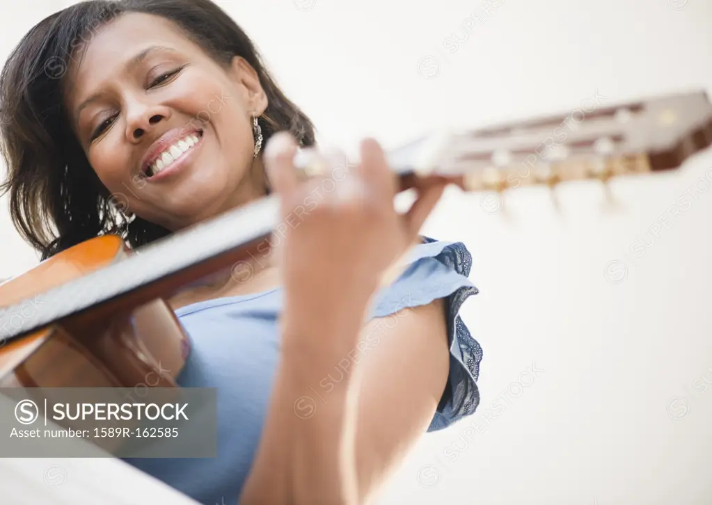 Black woman playing guitar