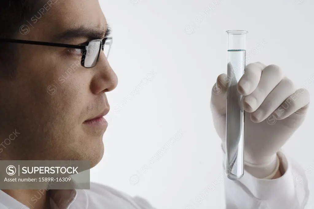 Scientist examining chemicals in a test tube