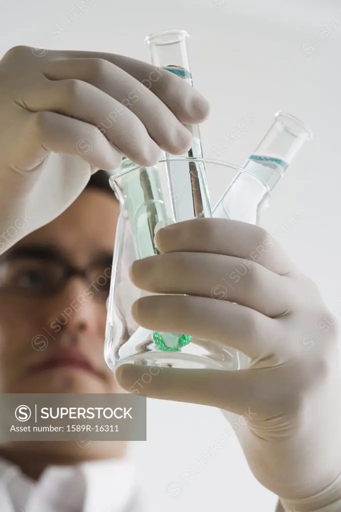 Scientist examining chemicals in test tubes