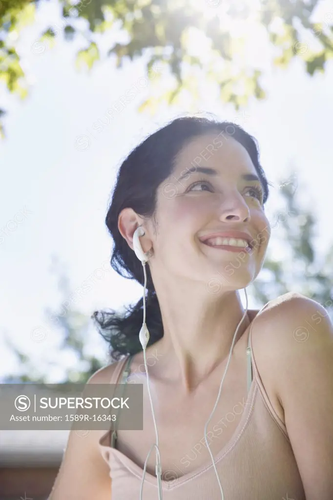 Young woman listening to earbuds