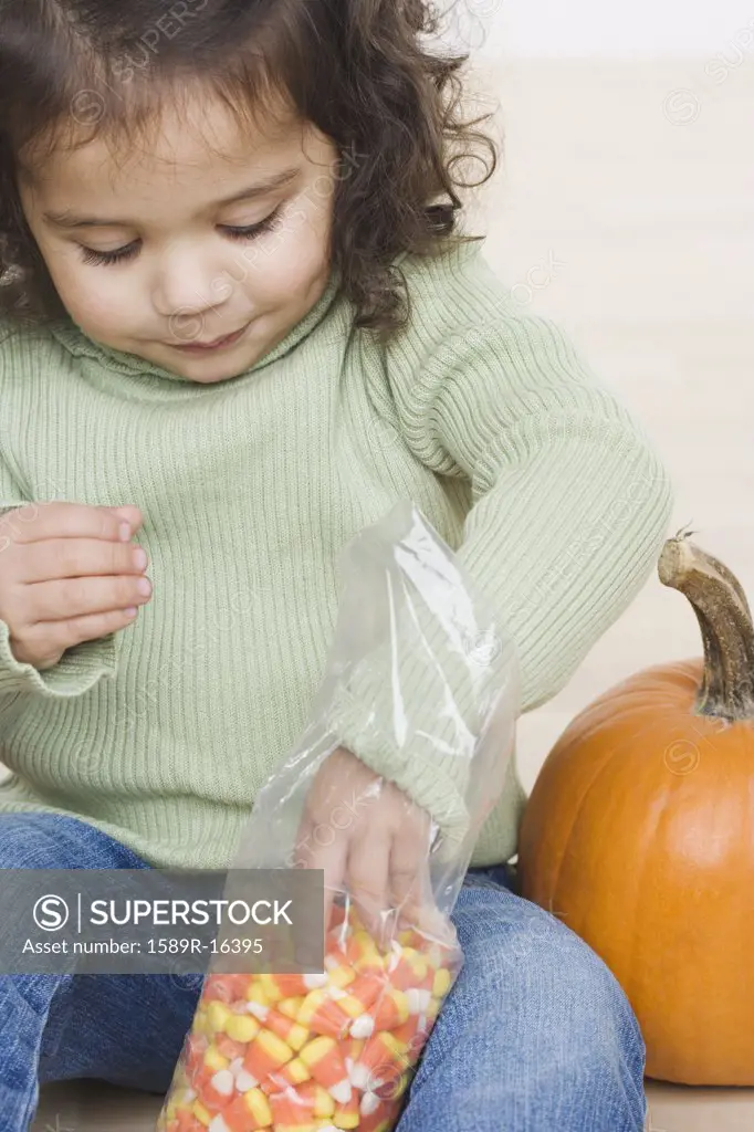 Little girl eating candy corn