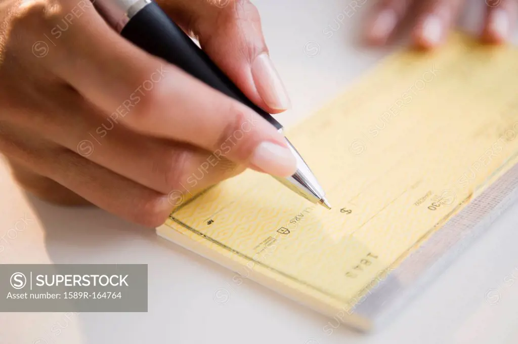 Cape Verdean woman writing a check