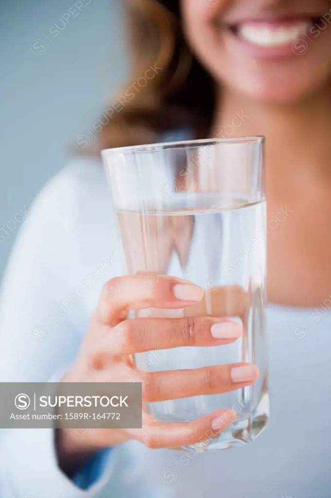 Cape Verdean woman holding glass of water