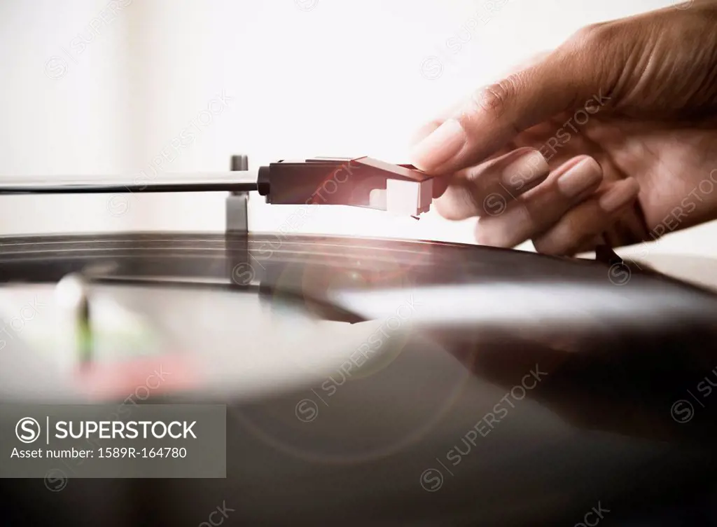 Cape Verdean woman listening to vinyl record