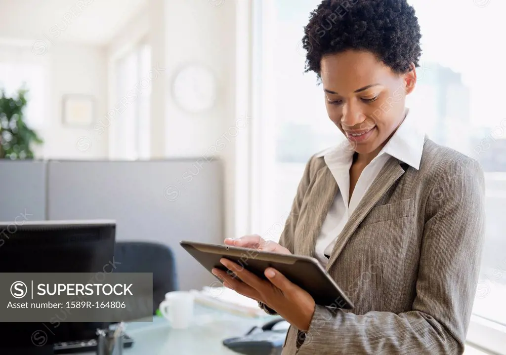 African American businesswoman using digital tablet in office