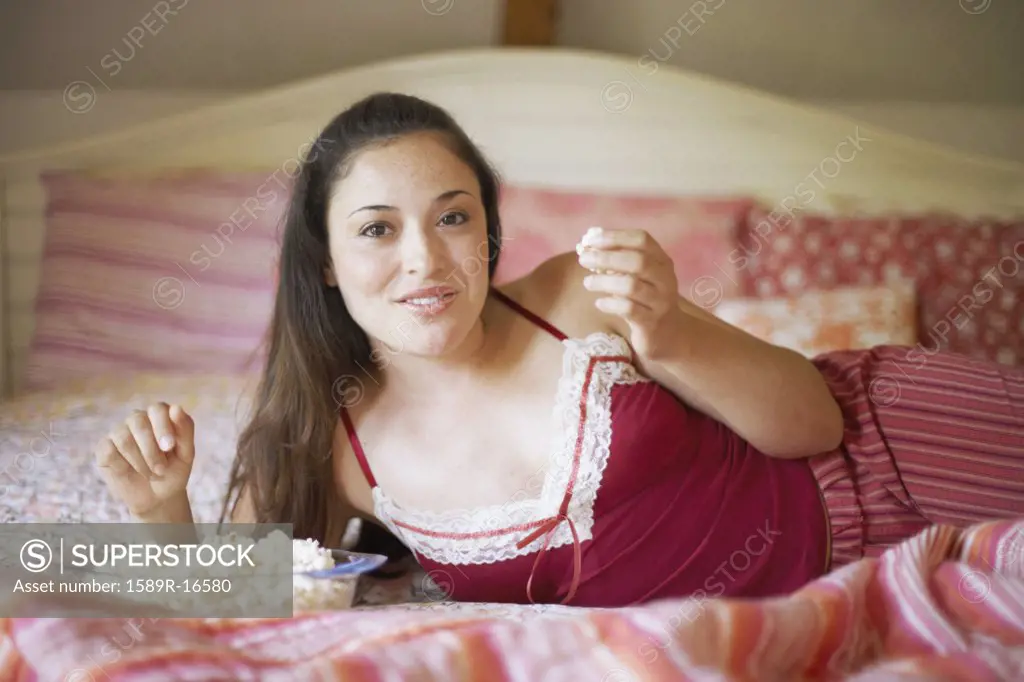 Young woman relaxing on her bed