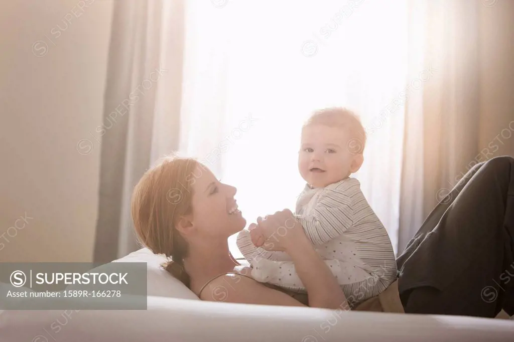 Caucasian mother playing with son