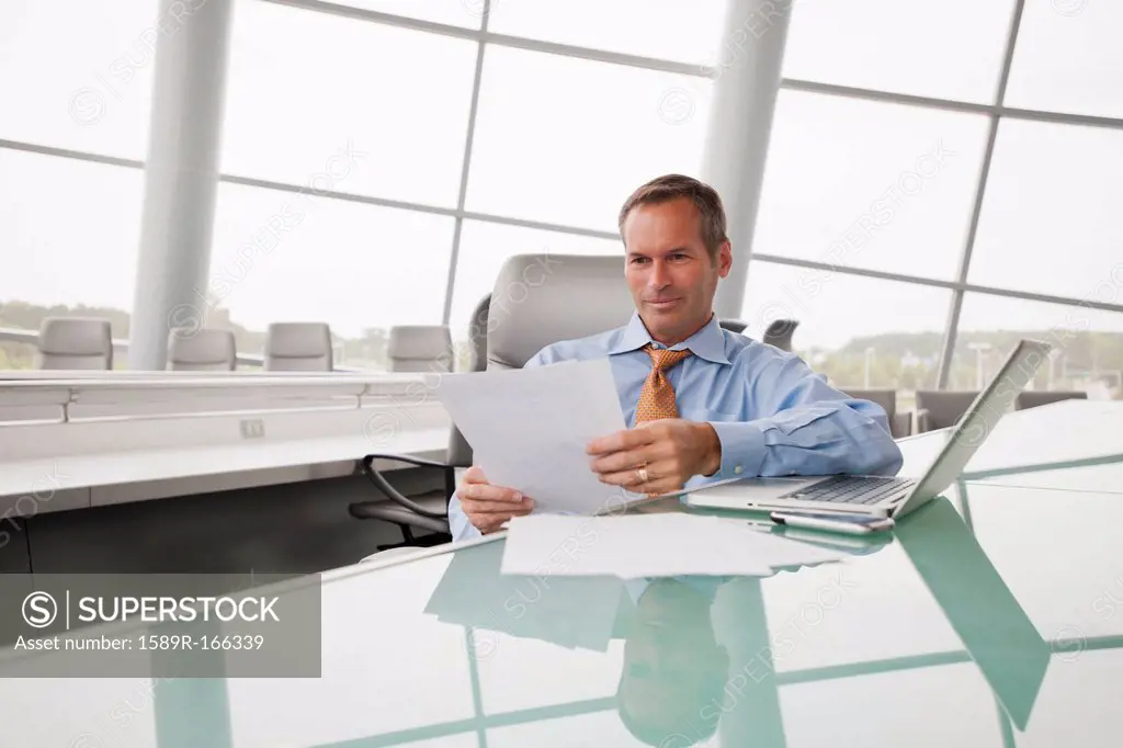 Caucasian businessman working in conference room