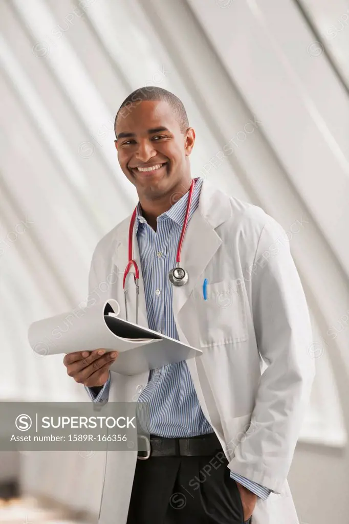Smiling Black doctor standing with hands in pockets