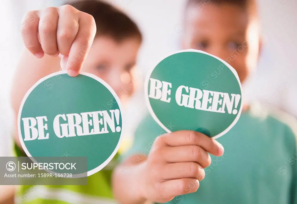 Boys holding Be Green signs