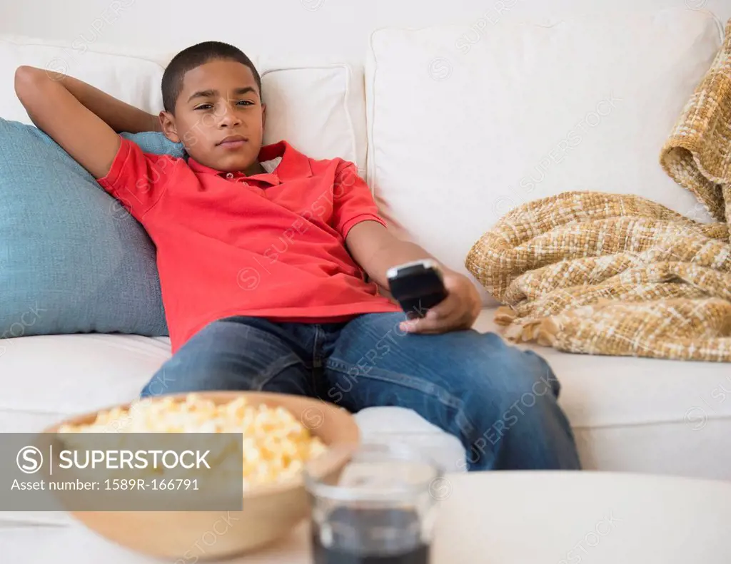 Hispanic boy watching television