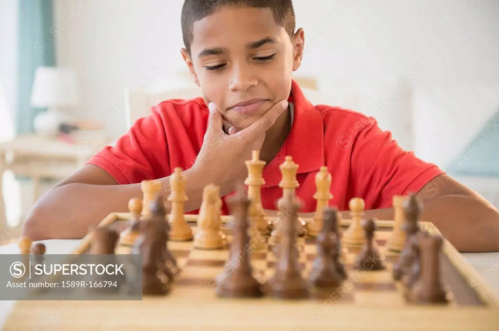 Hispanic boy playing chess